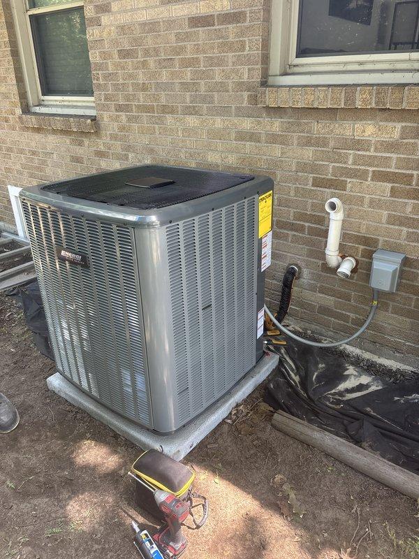 Completed add-on air conditioning installation to existing forced-air heating system. Installed Goodman brand outdoor condensing unit on concrete pad with proper refrigerant line sets insulated with black jacketing, established electrical disconnect, and routed PVC condensate drainage along exterior wall. Added indoor evaporator coil cabinet adjacent to existing furnace in basement utility area, connected supply and return ductwork with flexible transitions, and integrated system controls. Tested system operation, verified proper airflow, confirmed refrigerant charge, and ensured all connections meet manufacturer specifications.