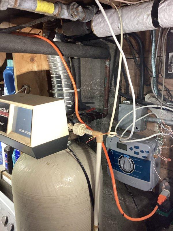 Completed routine maintenance on tank-style water heater and water softener system in 1948-built residence. Customer reported intermittent banging noise occurring randomly at night, with unclear origin between water heater or softener unit. Performed comprehensive inspection of both systems in mechanical room, checking for loose components, sediment buildup, and pressure irregularities that could cause hydraulic shock or water hammer. Conducted water quality testing using pH and iron test kit to assess softener performance and water chemistry. Inspected water softener control unit, regeneration cycle settings, and brine tank operation. Examined water heater for sediment accumulation, anode rod condition, and temperature-pressure relief valve function. Evaluated all supply lines, drain connections, and expansion tank if present. Assessed ductwork and mechanical room configuration for potential noise transmission issues. Documented equipment conditions and water quality parameters throug