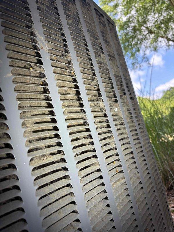 Completed annual cooling maintenance visit on EnergiAir system under active warranty coverage through 2029. Performed comprehensive inspection of outdoor condenser unit, noting significant dirt and debris accumulation on louver vents and horizontal slat surfaces requiring cleaning attention. Inspected indoor components including basement installation area with PVC drainage system and associated plumbing connections, verifying proper operation and drainage functionality. System operational at time of service completion.