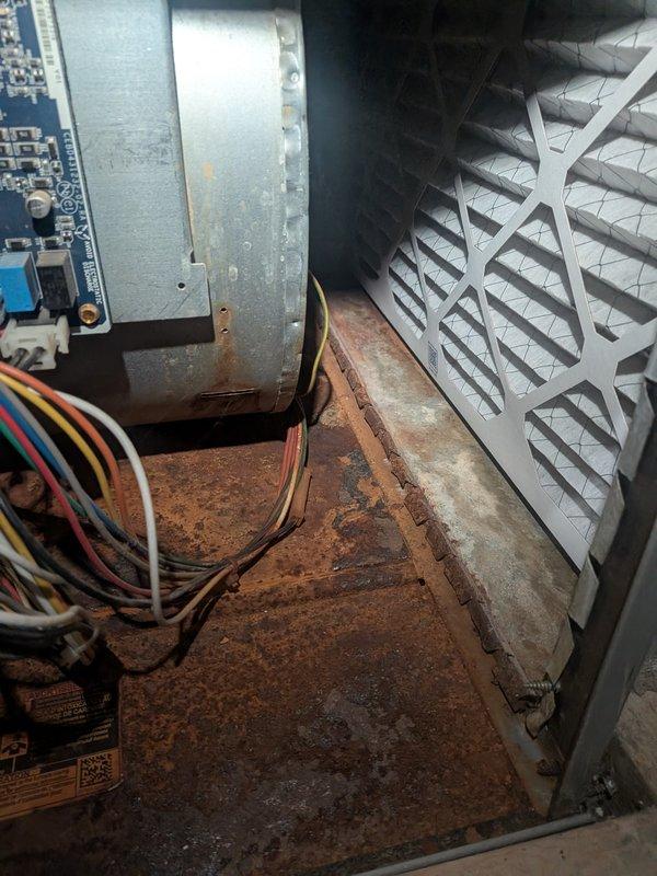 Completed ASTU-AC Super Tune-up on 9-year-old air conditioning system for new homeowner experiencing inadequate cooling to upstairs bedrooms. Performed comprehensive inspection revealing significant rust and corrosion accumulation in furnace/air handler compartment base, which could impact system efficiency and longevity. Inspected electrical components, circuit board, and wiring connections; all appeared functional despite visible age-related deterioration in unit. Evaluated airflow distribution issues affecting second-floor cooling; likely causes include inadequate ductwork sizing to upper level, possible damper adjustment needs, or insufficient system capacity for multi-story application. Recommended monitoring rust progression and considering future air handler replacement due to corrosion severity, along with ductwork assessment to address uneven temperature distribution throughout home.