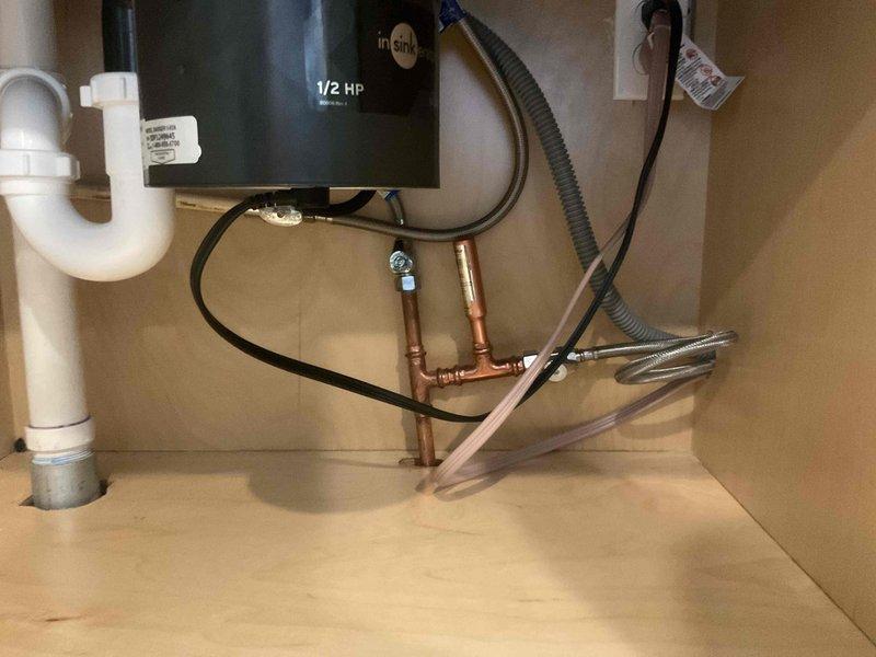 Installed water hammer arrestor on dishwasher supply line to eliminate banging noise when appliance cycles off. Integrated arrestor into existing copper plumbing configuration beneath sink using appropriate compression fittings, ensuring proper positioning for optimal shock absorption and maintaining full water flow to dishwasher.