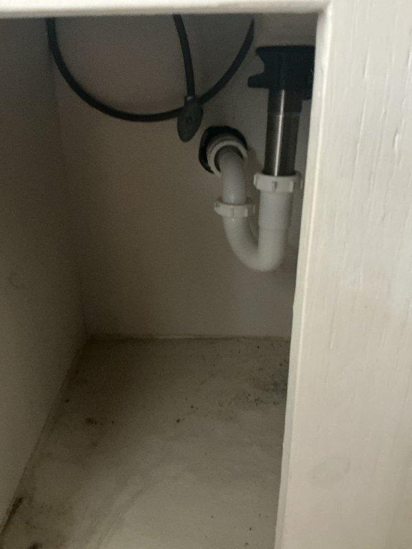 Completed faucet replacement on bathroom vanity sink, removing existing worn fixture and installing new chrome single-handle faucet with dual side handles. Verified proper drainage through P-trap assembly, tested water supply connections for leaks, and confirmed full functionality of new faucet and drain stopper mechanism.