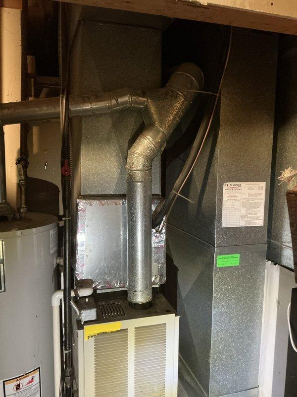 Completed full HVAC system replacement estimate for 27-year-old International Comfort Products system with non-functional central air conditioning due to refrigerant leak. Assessed existing furnace and AC unit serving entire house, documented current equipment configuration including indoor air handler with ductwork connections and outdoor condenser unit, and provided replacement options with financing information through Michigan Saves program.