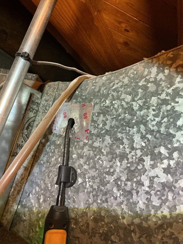 Returned to property to perform refrigerant leak search on HVAC system. Conducted thorough inspection of refrigerant lines in attic space, examining copper piping and insulated line connections at junction points. Utilized electronic leak detection equipment to test refrigerant lines and fittings throughout accessible areas. Documented findings with photos of refrigerant line routing and connection points for service records.