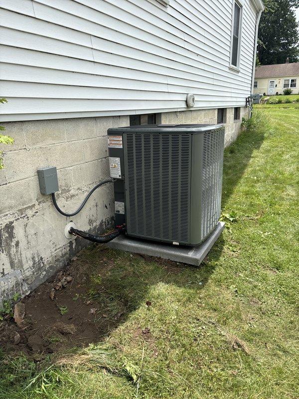 Completed full installation of new furnace and air conditioning system. Outdoor condenser unit was positioned on concrete pad against foundation with proper clearance for airflow, electrical disconnect box mounted to foundation wall, and all necessary conduit and wiring connections completed. System was installed per manufacturer specifications and prepared for operation.