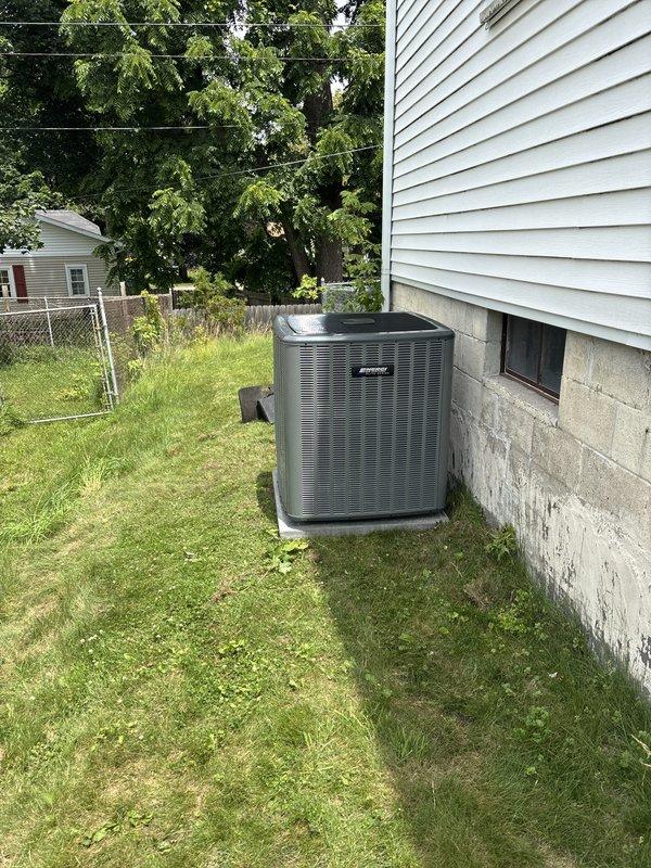 Completed full installation of new furnace and air conditioning system. Outdoor condenser unit was positioned on concrete pad against foundation with proper clearance for airflow, electrical disconnect box mounted to foundation wall, and all necessary conduit and wiring connections completed. System was installed per manufacturer specifications and prepared for operation.