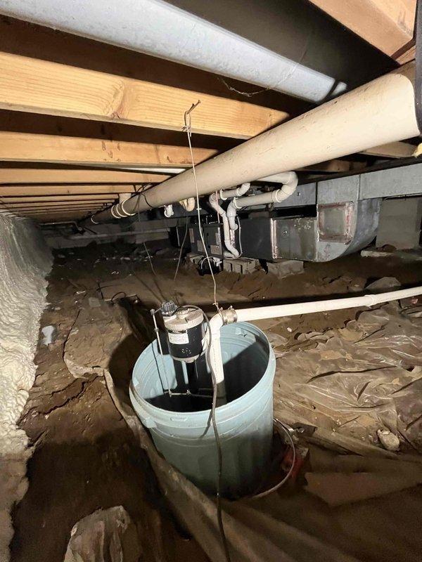 Completed comprehensive furnace and air conditioning system installation at residential property. Installed new outdoor condensing unit on concrete pad with proper electrical conduit connection and positioned unit on decorative stone base for drainage and stability. Performed crawl space work including HVAC ductwork installation, integrated system with existing sump pump infrastructure, and ensured proper routing of PVC drainage lines and electrical connections throughout subfloor area. All work completed per approved scope, system tested and operational.