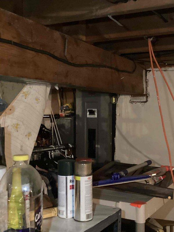 Conducted furnace and air conditioning replacement estimate for 15-year-old HVAC system. Documented existing equipment location in basement utility area and exterior utility connections including electrical service and metering. Customer requested quote through online booking system.