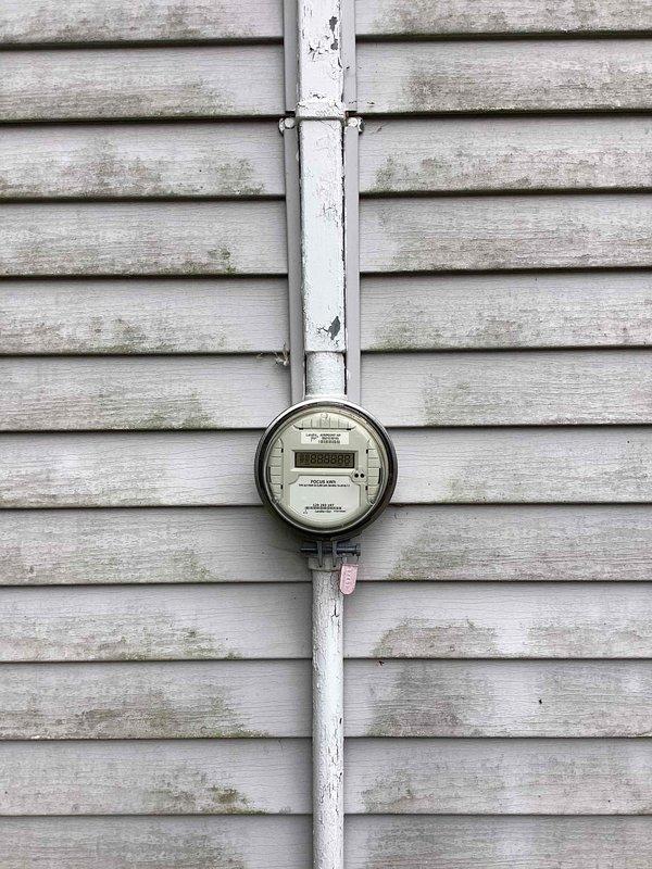 Conducted furnace and air conditioning replacement estimate for 15-year-old HVAC system. Documented existing equipment location in basement utility area and exterior utility connections including electrical service and metering. Customer requested quote through online booking system.