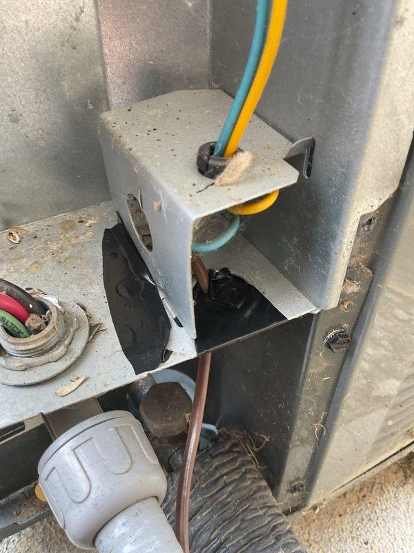 Completed annual cooling maintenance on EnergiAir system with 3-year service agreement. Performed comprehensive inspection of outdoor unit electrical disconnect box and control panel, noting significant weathering and environmental exposure consistent with outdoor installation. Cleaned accumulated debris, dirt, and insect remains from electrical enclosure and control components. Inspected all electrical connections including terminal blocks with multi-circuit wiring configuration, verified proper wire terminations and strain relief fittings on incoming power lines. Examined refrigerant line connections and flexible conduit routing. System operational and ready for cooling season.
