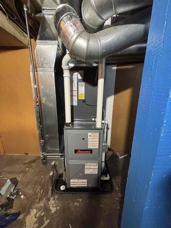 Completed full residential HVAC system installation in basement utility area, including new Amana brand furnace unit and air conditioning system. Installed furnace with complete ductwork integration, including metallic supply ducts, flexible ducting connections, and PVC condensate drainage and venting piping. Connected all ductwork to existing home distribution system, secured unit against concrete block walls in corner configuration, and verified proper system operation and airflow throughout installation.