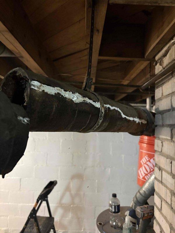 Completed full home drain repipe in basement area, replacing deteriorated drainage systems with new PVC piping throughout the crawl space. Removed compromised ductwork showing extensive surface deterioration and flaking, installed new drainage lines along ceiling joists, and ensured proper routing around existing brick chimney structure and mechanical equipment. All new piping secured to structural beams with appropriate hangers, tested for proper flow and drainage, and workspace cleaned upon completion.