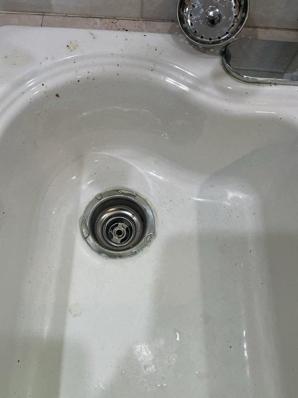 Responded to kitchen sink backup caused by food debris in garbage disposal. Upon inspection, found disposal drain line and P-trap partially obstructed with organic material. Cleared blockage from disposal unit and drain assembly, flushed system to restore proper drainage flow. Tested sink and disposal operation to confirm complete resolution of backup issue.