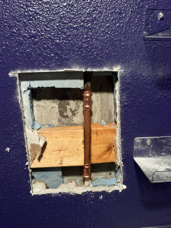 Responded to water leak emergency caused by screw penetration through copper water line in interior wall. Cut access opening in textured wall to expose damaged pipe section, verified leak location, and assessed extent of damage to surrounding wall materials. Repaired compromised copper plumbing line and restored water service to home.
