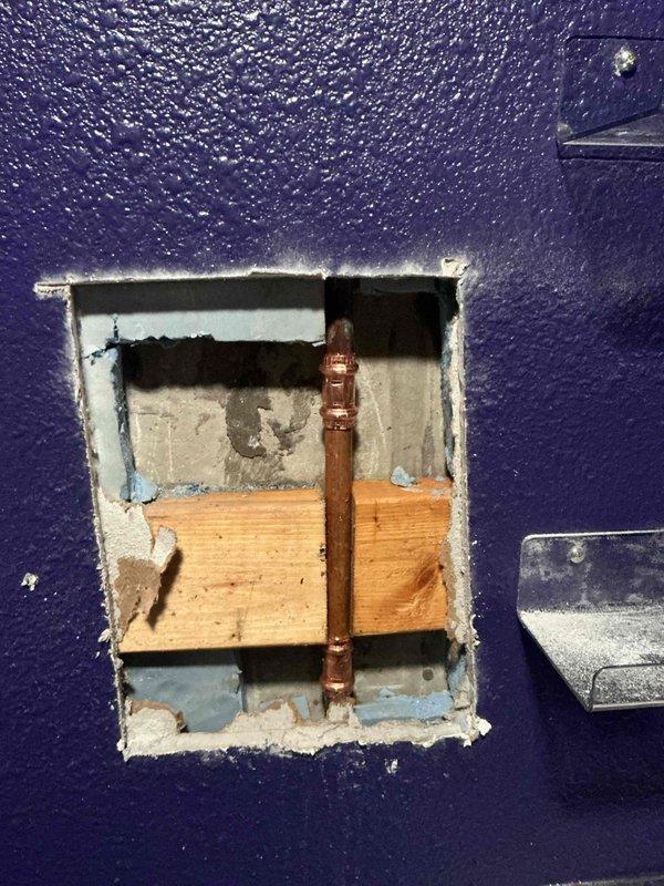Responded to water leak emergency caused by screw penetration through copper water line in interior wall. Cut access opening in textured wall to expose damaged pipe section, verified leak location, and assessed extent of damage to surrounding wall materials. Repaired compromised copper plumbing line and restored water service to home.