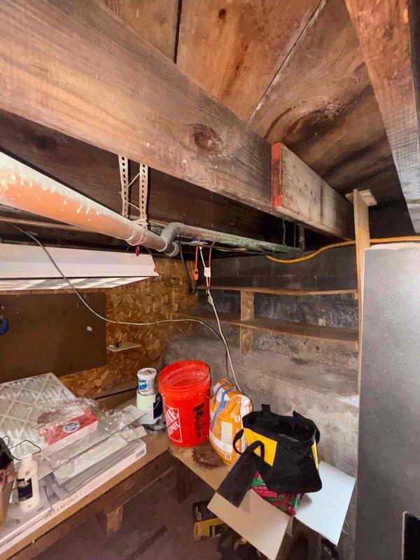 Responded to plumbing leak originating from dishwasher supply line in basement utility area. Upon inspection, identified active leak at connection point requiring immediate attention to prevent further water damage to concrete foundation and surrounding infrastructure. Assessed existing plumbing system consisting of mixed-age materials including newer red PEX piping, white PVC, and older corroded steel pipes running through exposed ceiling joists. Secured leak source, completed necessary repairs to dishwasher supply line connection, and verified system integrity with pressure test to ensure no additional leaks present in the immediate plumbing network.