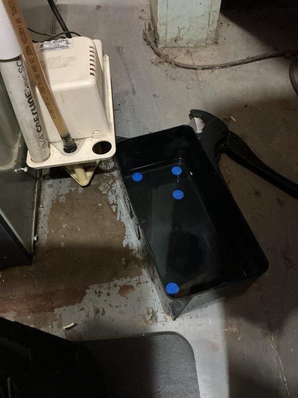 Completed annual cooling maintenance on 8-year-old AirTemp/Nortek system with condenser manufactured in 2022. Inspected condensate pump assembly and drainage system in mechanical room, noting proper operation of pump with visible float mechanism and confirmed adequate drainage through PVC piping into stainless steel drain pan. Documented equipment condition showing normal wear patterns on condensate management components and verified secondary drain pan positioning with proper standoff supports.