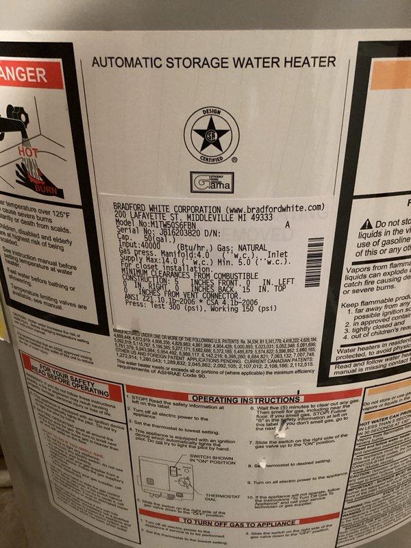 Responded to a 14-year-old Bradford White automatic storage water heater experiencing control box malfunction indicated by three green blinks followed by three seconds of no activity. Upon arrival, confirmed the blinking pattern and attempted to adjust temperature settings, which triggered unusual muffled beeping sounds originating from the exhaust fan area. Documented unit specifications and current condition with photographs showing manufacturer data plate with 40,000 BTU natural gas input rating and installed plumbing configuration with PVC piping and red foam insulation in exposed framing. The intermittent control board signaling combined with abnormal exhaust fan acoustics suggests potential issues with the electronic control module or blower motor assembly requiring further diagnostic evaluation or component replacement to restore proper operation.