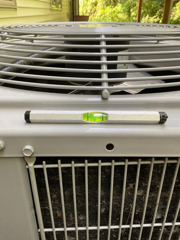Completed annual cooling maintenance on 2022 Carrier condensing unit. Verified unit level, inspected condenser coil and protective cage, checked mounting hardware and drainage, and documented equipment condition with photos. All components operating within normal parameters.