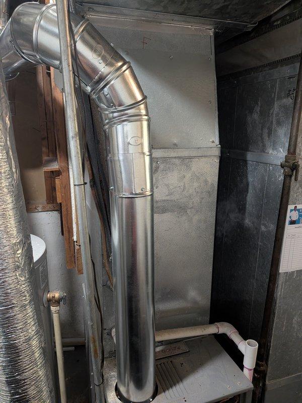 Completed exhaust flue replacement on residential HVAC system. Removed existing deteriorated vent piping and installed new stainless steel segmented flue pipe with proper elbow configuration to ensure safe venting of combustion gases. Verified all connections are secure, properly sealed, and meet code requirements. System tested and operating safely with adequate draft and no exhaust leaks detected.