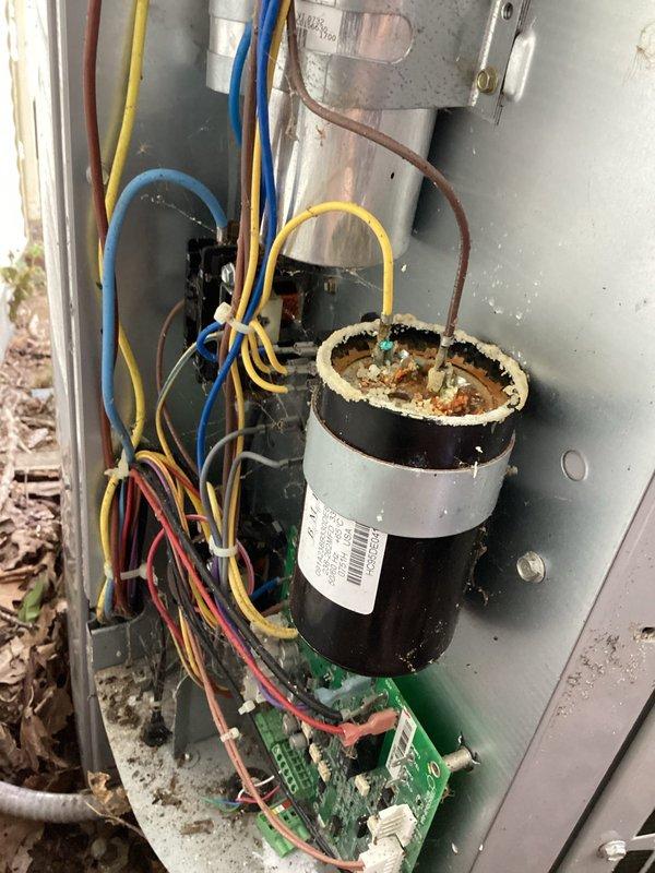 Responded to no cooling complaint with fan operational. Upon inspection, found failed capacitor with visible corrosion and rust on terminals. Capacitor exhibited signs of age-related deterioration with oxidation present at connection points. Replaced defective capacitor with new unit, reconnected all electrical leads, and verified proper wire routing. Tested system operation and confirmed compressor engagement and normal cooling function restored. Unit returned to full operational status.