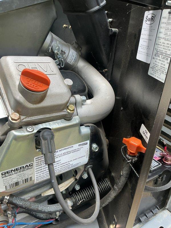Responded to a generator service call for a 10-year-old Generac unit experiencing operational issues for approximately three weeks. Performed comprehensive diagnostic inspection of the generator system, including examination of the engine compartment, coolant reservoir with orange cap, coolant hoses, and associated mechanical components. Inspected internal components including alternator assembly, mounting hardware, and electrical connections. Documented equipment condition through photographic records showing engine block with Generac identification labels, cooling system components, and interior mechanical assemblies. Verified proper installation specifications and assessed overall system integrity. Generator unit serviced at a residential property with the home structure being approximately 20 years old.