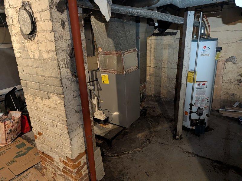 Provided estimate for replacement of 12+ year old Rheem water heater located in basement utility room. Unit assessed and photographed, showing standard wear consistent with age, with copper supply lines and standard venting configuration in place. Customer advised of replacement options and scheduling availability.