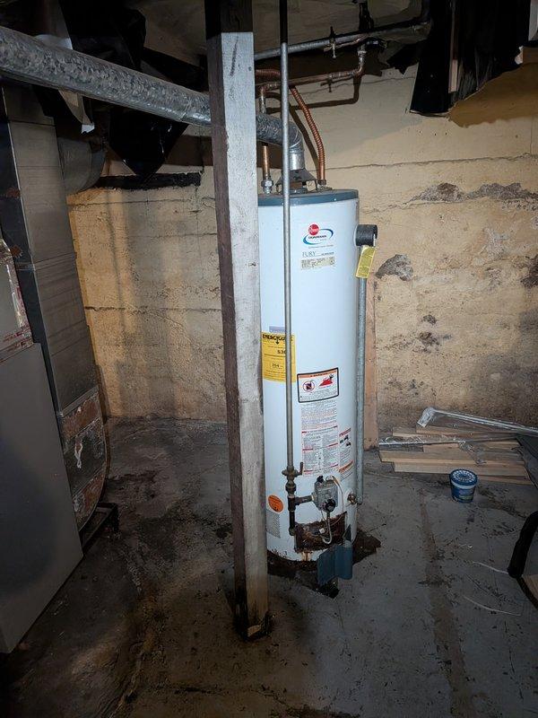 Provided estimate for replacement of 12+ year old Rheem water heater located in basement utility room. Unit assessed and photographed, showing standard wear consistent with age, with copper supply lines and standard venting configuration in place. Customer advised of replacement options and scheduling availability.