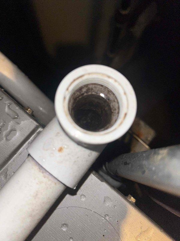 Responded to water leak concern on 9-year-old HVAC system. Upon inspection, discovered significant corrosion and oxidation on evaporator coil assembly with visible rust-colored patina throughout copper tubing. Identified compromised condensate drain system with staining and debris accumulation in PVC drainage piping. Documented condition of heat exchanger coil showing advanced deterioration and assessed condensate pan for proper drainage function. Provided maintenance service and recommendations for system repair to resolve active water leak issue.