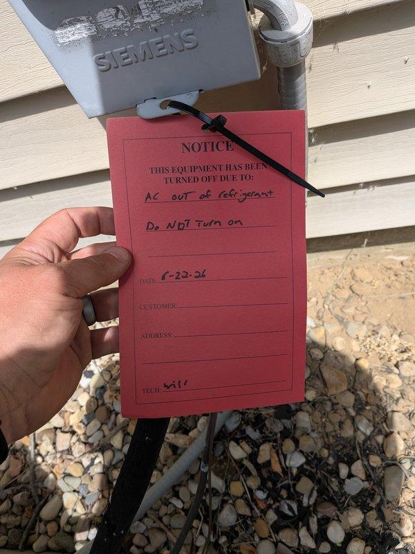 Completed AC super tune-up on 32-year-old system. During inspection, discovered unit was completely out of refrigerant. Tagged equipment with red notice indicating "AC out of refrigerant" and "Do NOT Turn on" to prevent compressor damage from operating without proper charge. System requires refrigerant recharge and leak detection before returning to service.