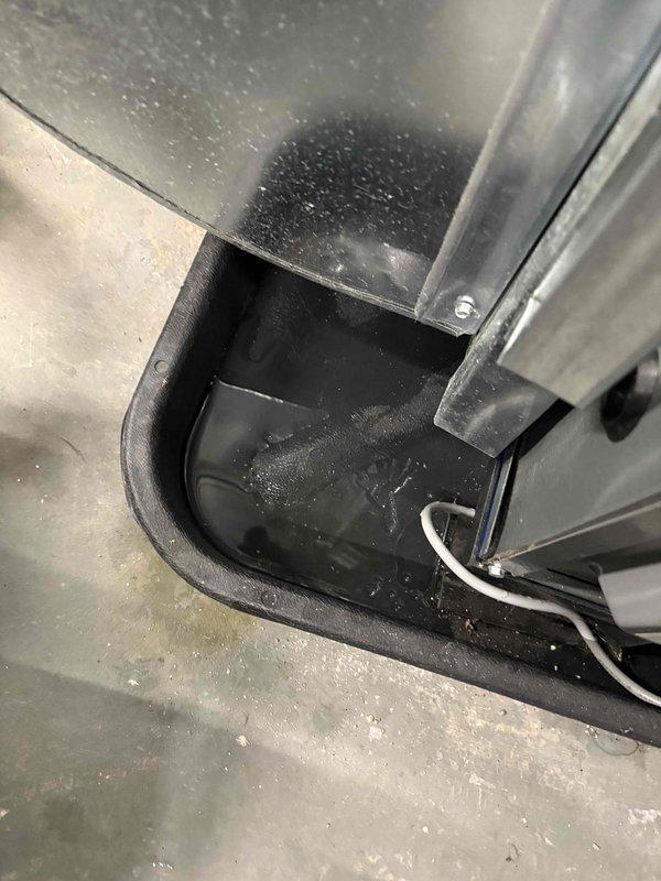 # No Cool Service Call - York AC Unit

Responded to a no cooling complaint on an 11-year-old York air conditioning system. Upon arrival, inspected the indoor unit and condensate drainage system. Found evidence of excessive moisture accumulation in the drain pan with standing water present, indicating a potential drainage issue affecting system operation. Photographed the condensate drain pan assembly, PVC drainage lines, and associated plumbing components for documentation. The drain pan showed significant water pooling with visible moisture on metal ductwork surfaces above, suggesting condensation management concerns. Observed the condensate pump assembly and horizontal drain piping configuration. System exhibited signs of compromised drainage that could lead to safety float switch activation, which would shut down the unit to prevent overflow damage. Documented the condition of all drainage components including elbow fittings, vertical and horizontal PVC sections, and the metal drain