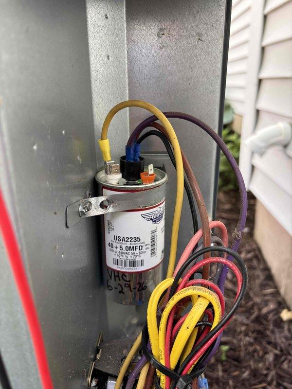 Responded to no-cool call on 10-year-old air conditioning system. Upon arrival, confirmed outdoor unit was not operating. Performed diagnostic testing and identified failed dual-run capacitor (40+5 MFD) preventing compressor and condenser fan motor from starting. Replaced defective capacitor with OEM equivalent, verified proper electrical connections with color-coded wiring, and tested system operation. Unit restored to full cooling capacity with normal amp draw on compressor and fan motor. Documented installation with photos showing component replacement and existing furnace/air handler configuration.