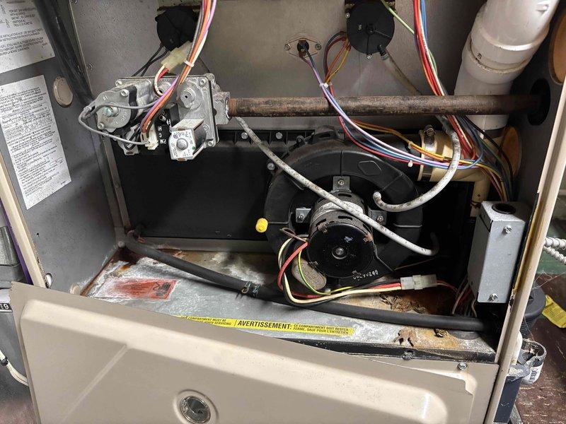 Responded to no-cool call on 10-year-old air conditioning system. Upon arrival, confirmed outdoor unit was not operating. Performed diagnostic testing and identified failed dual-run capacitor (40+5 MFD) preventing compressor and condenser fan motor from starting. Replaced defective capacitor with OEM equivalent, verified proper electrical connections with color-coded wiring, and tested system operation. Unit restored to full cooling capacity with normal amp draw on compressor and fan motor. Documented installation with photos showing component replacement and existing furnace/air handler configuration.