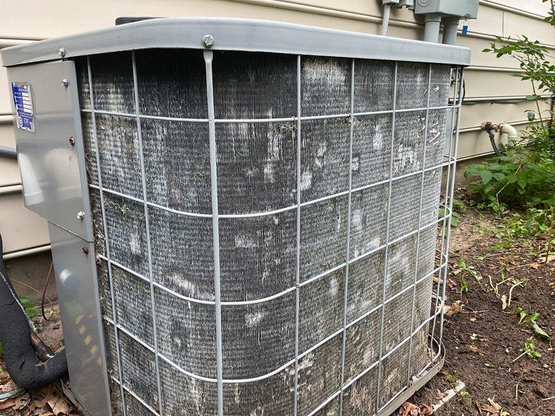 Responded to no cooling complaint on 15-year-old residential air conditioning system. Upon inspection, found outdoor condensing unit operational but with severely clogged condenser coils restricting airflow and preventing adequate heat transfer. Electrical components showed signs of weathering with disorganized wiring but contactor and capacitor appeared functional. Cleaned condenser coils to remove heavy accumulation of dirt, dust, and debris. Verified proper system operation and adequate cooling performance restored. Recommended ongoing maintenance to prevent future efficiency loss.