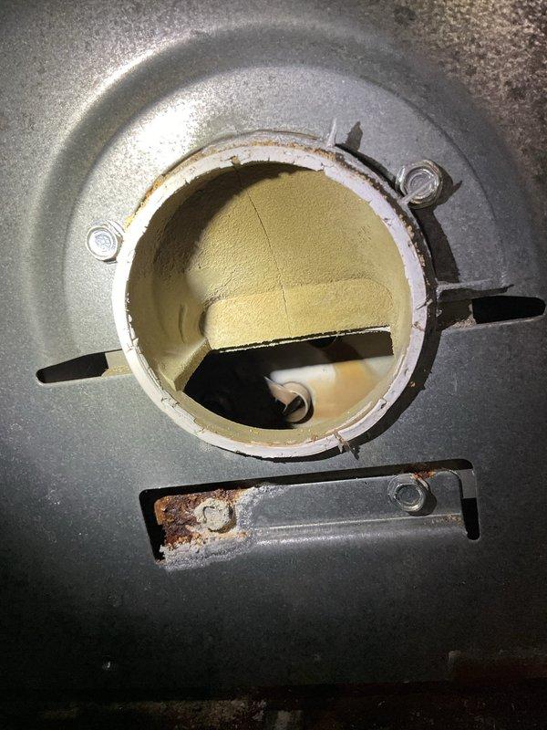 Responded to service call for 20-year-old cooling unit blowing lukewarm air instead of cold air. Upon inspection, accessed interior components through existing service panels and documented significant corrosion and rust around access points and metal surfaces, indicating age-related deterioration and possible moisture exposure. Identified compromised insulation material and corroded metal components within the air handling system that may be contributing to reduced cooling efficiency and improper temperature output.