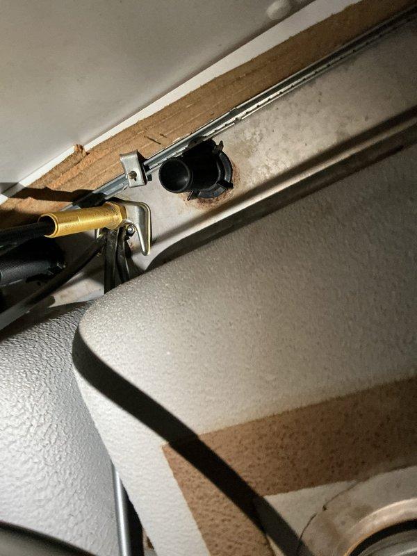Responded to service call for newly installed kitchen faucet that was loose and unstable at mounting point. Tightened mounting hardware and securing nut beneath sink deck to properly stabilize the single-handle chrome faucet assembly on the stainless steel sink basin, ensuring fixture was secure and operational.