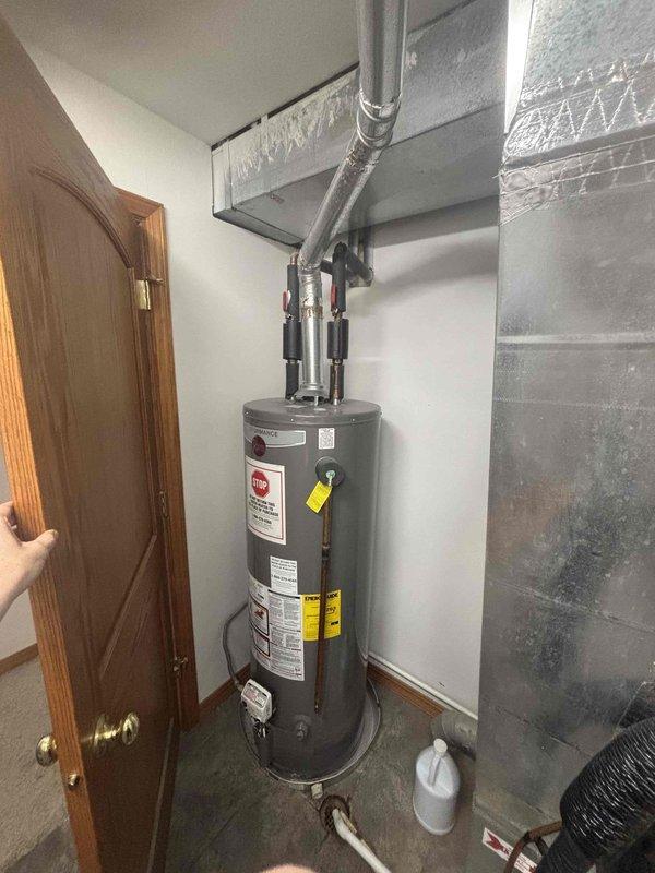 Completed annual cooling system maintenance inspection and tune-up service. Performed comprehensive AC system evaluation including refrigerant levels, electrical connections, and operational efficiency testing. Addressed customer inquiry regarding water heater anode rod replacement necessity, explaining the three-year service interval and benefits of preventative maintenance for the EnergiAir water heater unit installed in 2022 with warranty expiration in 2032. Documented existing conditions of HVAC ductwork, plumbing connections, and mechanical equipment installation through photographic records. All systems operating within normal parameters upon service completion.