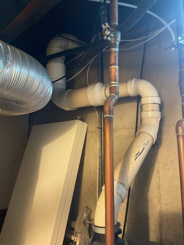 Provided estimate for replacement of 15-year-old Bradford White water heater located in unfinished basement utility area. Assessed existing plumbing configuration including copper supply lines, PVC venting system, and current equipment placement among exposed framing and mechanical systems. Documented site conditions and equipment specifications with photographs for proposal preparation.