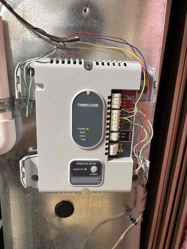 # NC-No Cool Service Completed

Responded to no cooling complaint on 12-year-old Goodman AC unit. Upon arrival, confirmed system was running but not producing cold air. Performed diagnostic inspection of both indoor and outdoor units.

Examined indoor air handler and found THM5320R wireless thermostat control module properly powered and connected, with all wiring intact at terminal strips. Verified thermostat was calling for cooling with COOL indicator illuminated.

Inspected outdoor condensing unit and discovered significant deterioration of internal components. Access panel revealed degraded pink insulation material, extensive discoloration, and accumulated debris within electrical compartment. Condenser coil fins showed signs of age and weathering. Internal wiring bundle examined and found to be intact but compartment showed evidence of long-term exposure to elements and moisture intrusion based on corrosion patterns and material breakdown.

Given the age of the unit (12 years) and 