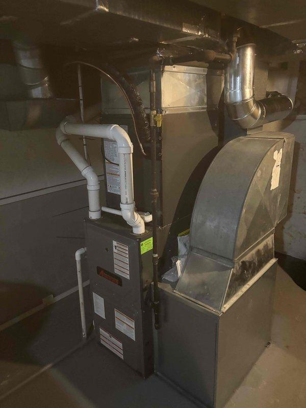 Successfully completed full air conditioning system replacement in residential basement mechanical room. Removed existing AC unit and installed new system with proper integration to existing furnace infrastructure. Connected metallic ductwork with galvanized elbow transitions to ensure optimal airflow distribution throughout the residence. Verified all electrical connections, refrigerant lines, and condensate drainage systems are properly installed and functioning to manufacturer specifications. System tested and operational upon completion.