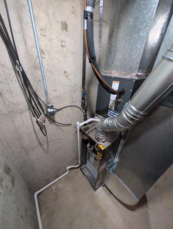 Successfully completed installation of new furnace and water heater in residential basement utility room. Installed modern high-efficiency furnace unit with proper ventilation ductwork, electrical connections, and PVC condensate drainage routing. Mounted and secured all HVAC equipment to manufacturer specifications, including proper wiring of blower motor assembly, heat exchanger components, and burner system with flame indicators. Verified all electrical conduits, wire connections, and safety controls are functioning correctly. System tested and operational upon completion.