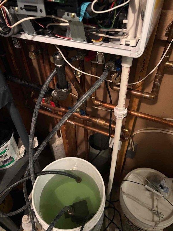 Responded to no hot water complaint on 5-year-old tankless water heater. Upon arrival, performed diagnostic evaluation and determined unit required descaling maintenance due to mineral buildup affecting heat exchanger performance. Flushed system using descaling solution circulated through heat exchanger via service pump and isolation valves. Completed full descaling procedure, restored unit to proper operation, and verified hot water delivery throughout home. Unit tested and left in working condition.
