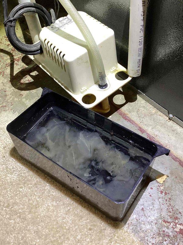 Completed annual cooling maintenance on 2018 residential HVAC system. Performed comprehensive tune-up including system inspection, refrigerant level verification, electrical component testing, and condensate drainage system evaluation. Addressed client inquiries regarding air filter options and provided recommendations for appropriate filter types based on system specifications. Inspected condensate pump assembly and drainage lines; noted standing water in collection pan with visible sediment accumulation. Documented system components and installation conditions through photographic records for maintenance history.