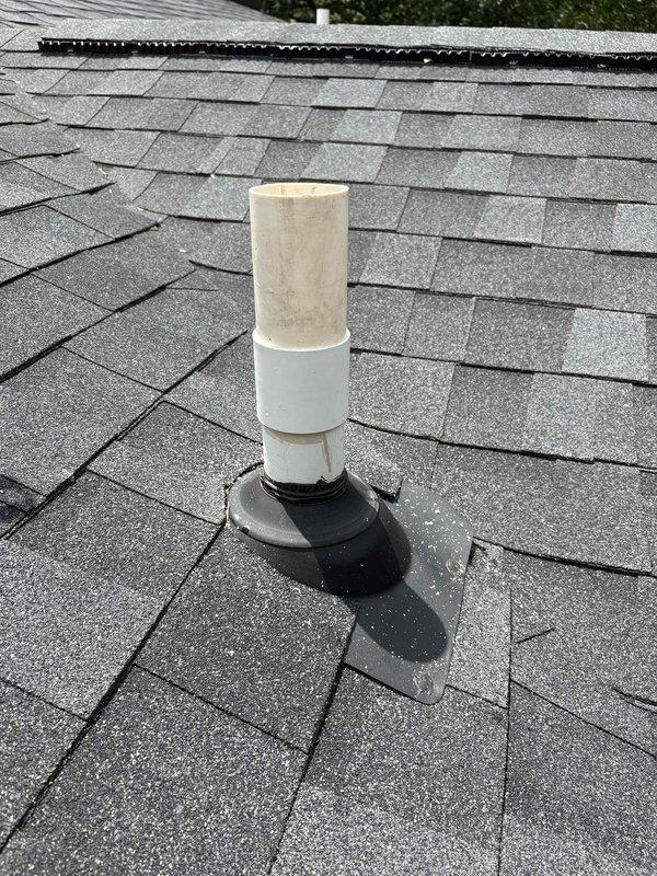 Responded to service call for damaged plumbing vent stack on north side of roof. Upon inspection, found missing section of PVC vent pipe above roof line. Replaced damaged upper section with new white PVC pipe, ensuring proper connection to existing lower section and verifying secure seal with rubber boot flashing at roof penetration. Vent stack restored to full functionality with proper venting capability maintained.