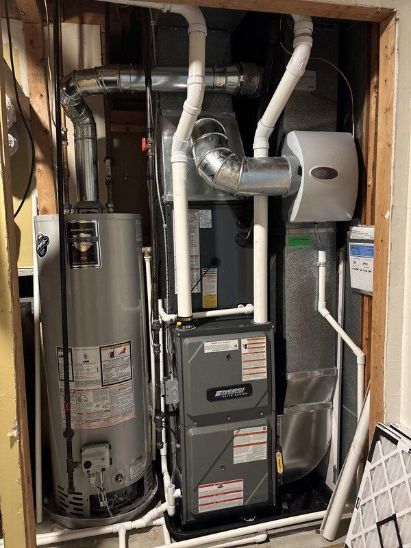 Completed full HVAC system installation including new furnace and air conditioning condenser unit. Installed outdoor AC condenser on concrete pad beneath elevated structure with proper electrical connections, conduit, and wiring routed to wall-mounted junction boxes. Interior furnace installation performed in mechanical closet with complete PVC venting system, including multiple elbows and proper termination. Integrated ductwork connections to existing metallic supply plenum and installed wall-mounted humidifier unit with corresponding ductwork and filtration. All copper refrigerant lines connected between indoor and outdoor units. Electrical service completed for both furnace and condenser with appropriate disconnect boxes. System tested for proper operation and airflow. Certificate of Completion documentation processed through electronic signature platform and submitted for financing approval through Michigan Saves program.