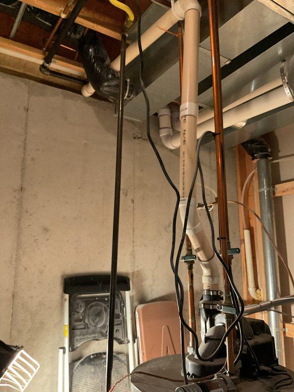 Responded to emergency service call for leaking water heater in residential property. Upon arrival, confirmed active leak from 7-year-old unit and verified that homeowner had shut off power to the equipment as previously advised by emergency services technician. Conducted thorough inspection of water heater and surrounding plumbing infrastructure, including copper supply lines, PVC drainage system, and flue venting components. Documented existing conditions with photographs showing utility room layout, exposed piping systems, electrical connections, and internal water heater components including heat exchanger with visible corrosion and oxidation. Assessed severity of leak and determined unit required replacement due to age and extent of deterioration observed on internal metallic components.