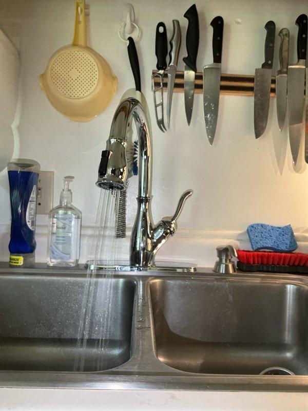 Returned to address previously installed faucet that was excessively loose and unable to secure properly to the basin. Upon inspection, determined the mounting hardware was defective and could not be adjusted to achieve proper fit. Replaced the faulty faucet unit with new fixture, secured mounting assembly to basin, connected supply lines to shut-off valves, and tested for proper operation and leak-free performance.