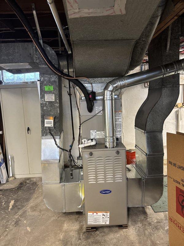 Completed full HVAC system installation in basement mechanical room, including new Carrier furnace unit and air conditioning system. Installed and connected all metal ductwork, plenums, and air handler components with proper sealing and support. Ran electrical conduit and wiring to furnace and auxiliary equipment, integrated humidifier system to furnace assembly, and verified all connections meet code requirements. System tested and operational upon completion.