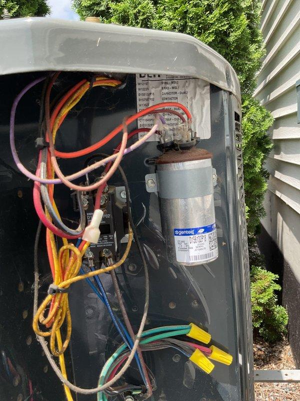 # No Cool Service Call - 8-Year Trane System

Responded to no cooling complaint on 8-year-old Trane air conditioning system. Performed diagnostic evaluation of outdoor condensing unit and indoor air handler components.

Inspected outdoor unit electrical compartment with access panel removed. Evaluated capacitor condition, contactor operation, and electrical connections. Capacitor showed proper specifications on Genteq label with secure wire connections at terminals. Verified all wire nuts properly secured and electrical components showed normal wear consistent with system age.

Examined indoor return air grille and found significant dust and debris accumulation on louvers and between slats, indicating restricted airflow. Accumulation was affecting system performance and cooling capacity.

Addressed airflow restriction issue and verified system operation. Unit returned to normal cooling function following service completion. Customer contacted via text per service request notes.