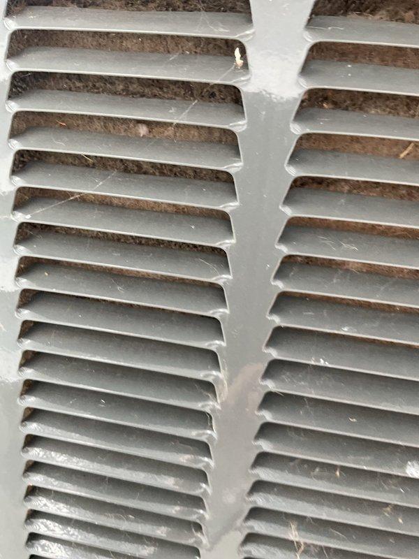 # No Cool Service Call - 8-Year Trane System

Responded to no cooling complaint on 8-year-old Trane air conditioning system. Performed diagnostic evaluation of outdoor condensing unit and indoor air handler components.

Inspected outdoor unit electrical compartment with access panel removed. Evaluated capacitor condition, contactor operation, and electrical connections. Capacitor showed proper specifications on Genteq label with secure wire connections at terminals. Verified all wire nuts properly secured and electrical components showed normal wear consistent with system age.

Examined indoor return air grille and found significant dust and debris accumulation on louvers and between slats, indicating restricted airflow. Accumulation was affecting system performance and cooling capacity.

Addressed airflow restriction issue and verified system operation. Unit returned to normal cooling function following service completion. Customer contacted via text per service request notes.
